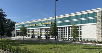 Exterior of the new Mavis Tires & Brakes store in Titusville, Florida, with green fascia and service bays