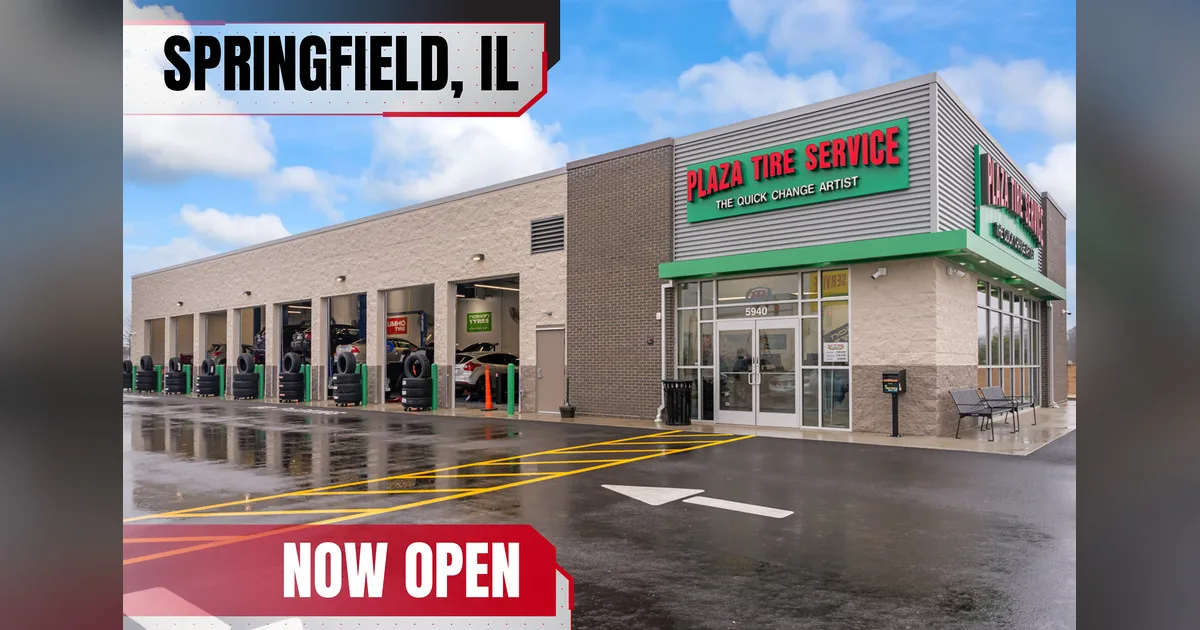 Exterior of the new Plaza Tire Service store in Springfield, Illinois, with open service bays and Springfield, IL and Now Open banners