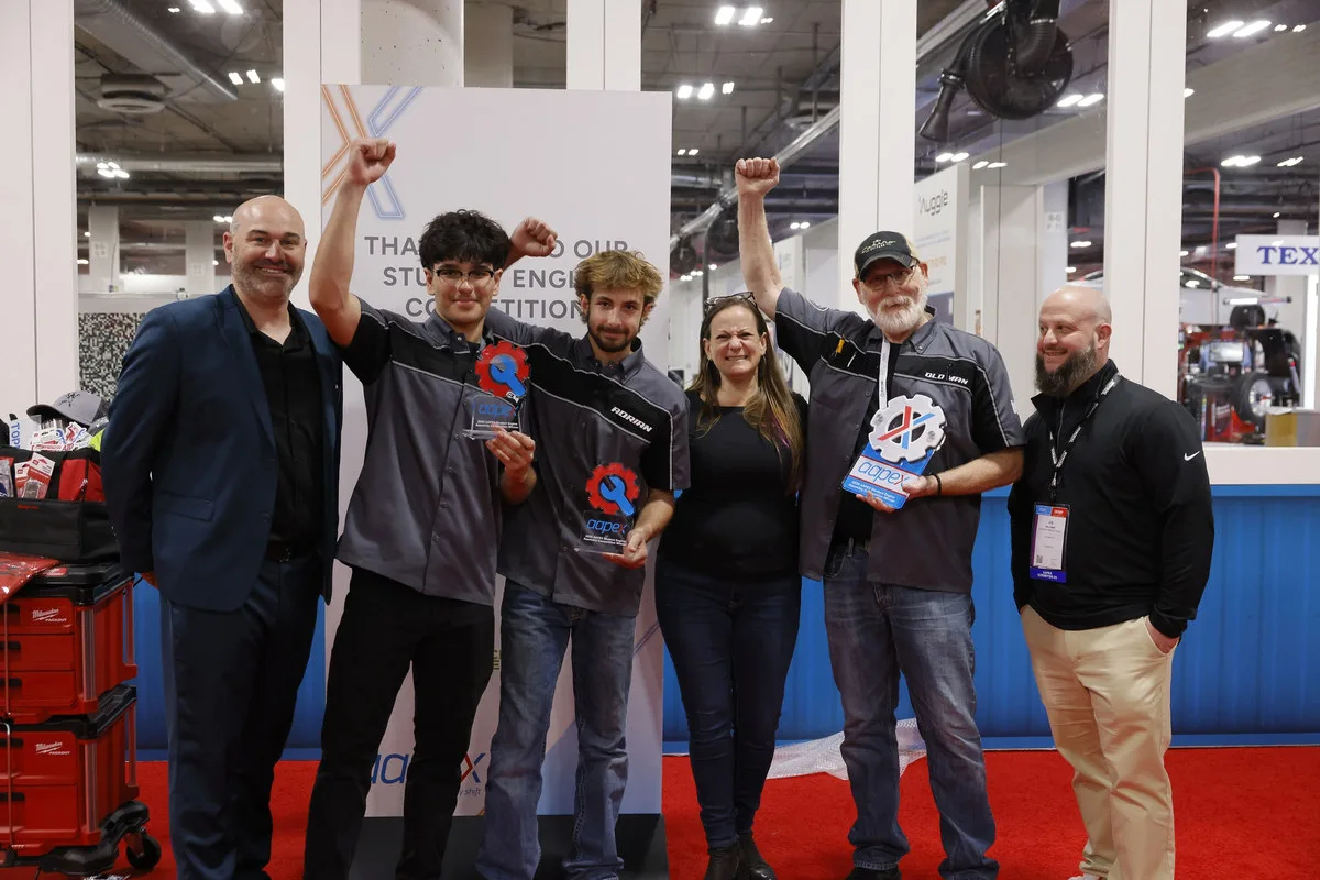 The winning high school team from the 2025 AAPEX student competition holding trophies with their coach, judges and event sponsor