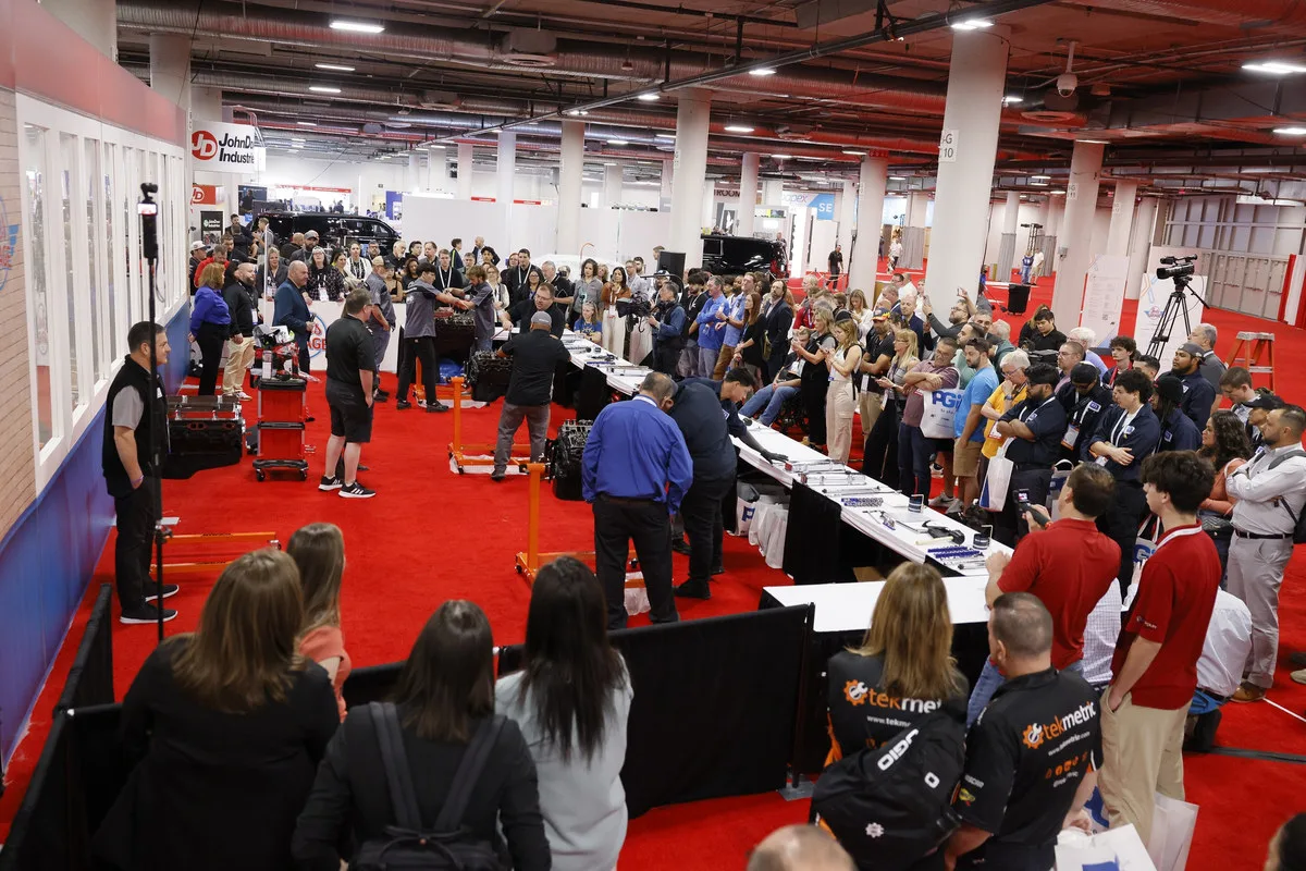 Wide view of the crowd gathered around the 2025 AAPEX student competition area