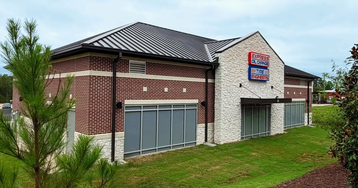 Exterior of the new Express Oil Change & Tire Engineers store in Chapin, South Carolina, a brick and stone building with a metal roof and red and blue signs