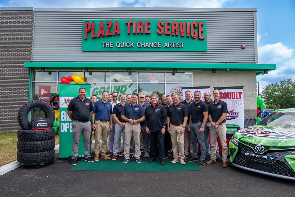 Sun Auto Network and Interstate Batteries leaders outside a Plaza Tire Service store at a grand opening