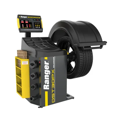 Ranger DST30PX wheel balancer in grey and yellow with a tire mounted under its hood