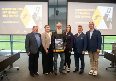 Joseph Stanekenas holds his 42nd Goodyear Highway Hero Award plaque alongside Goodyear and General Transport representatives
