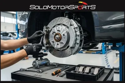 Solo Motor Sports technician working on a European car brake assembly