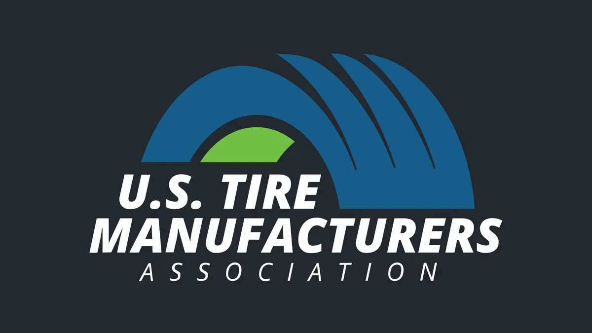 U.S. Tire Manufacturers Association logo with a blue tire-shaped arch and green center above white lettering, centered on a dark background.