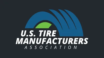 U.S. Tire Manufacturers Association logo with a blue tire-shaped arch and green center above white lettering, centered on a dark background.