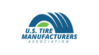 U.S. Tire Manufacturers Association logo, a blue tire-shaped arch with a green center and the association name in blue letters, centered on a white background.